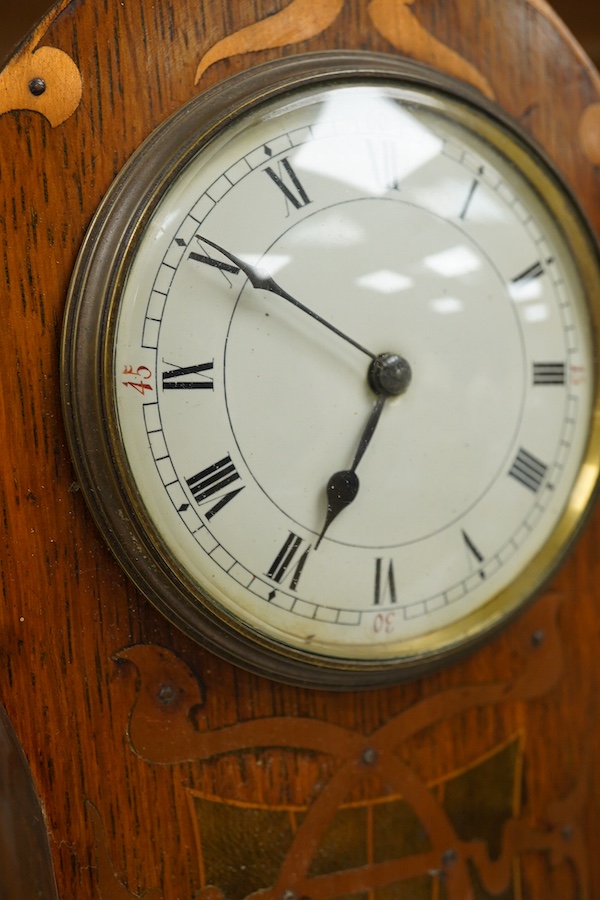 An Art Nouveau copper inlaid oak timepiece, 27cm high. Condition - various elements of copper inlay missing or detached